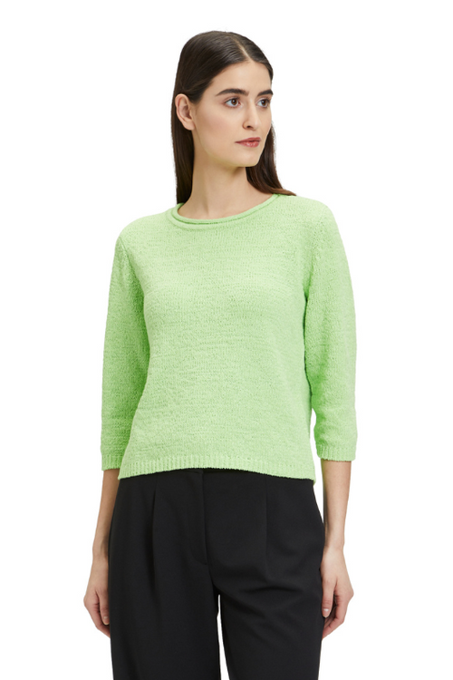An image of a female model wearing the Betty Barclay Chunky Knit Jumper in the colour Jade Lime.