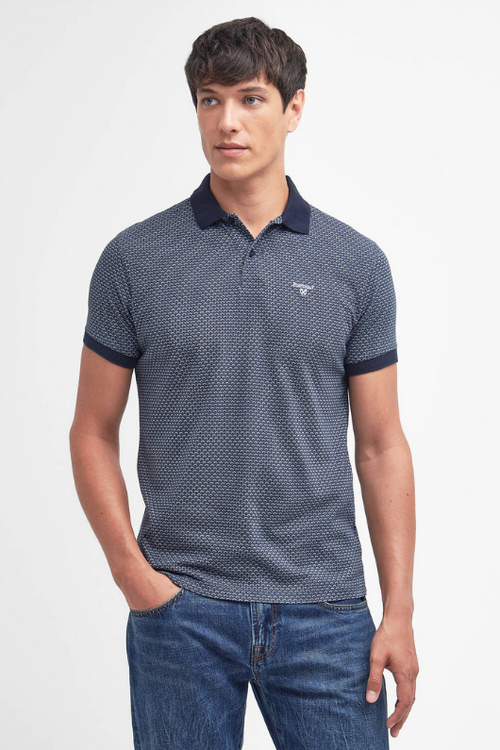 An image of a male model wearing the Barbour Shell Print Polo Shirt in the colour Classic Navy.