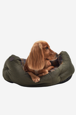 An image of a dog in the Barbour Quilted Dog Bed 30 inches in the colour Olive.
