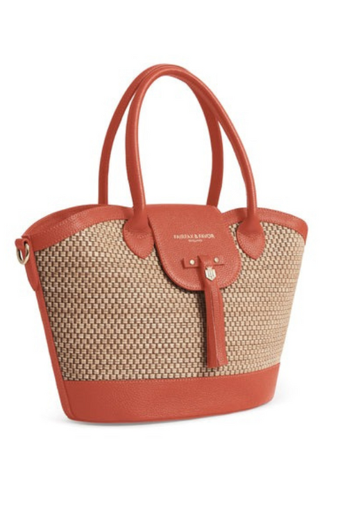 Fairfax & Favor Windsor Leather Basket Bag. A basket bag with Melon coloured details, tassel, crossbody strap, and studded base.
