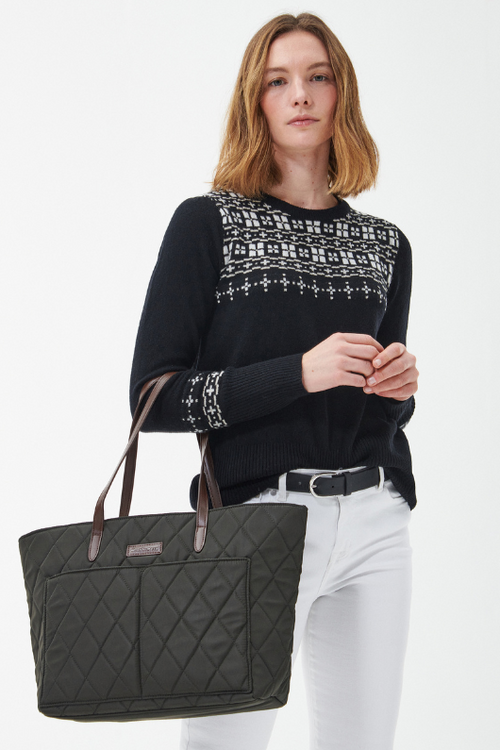 An image of a model wearing the Barbour Quilted Tote Bag in the colour Olive.