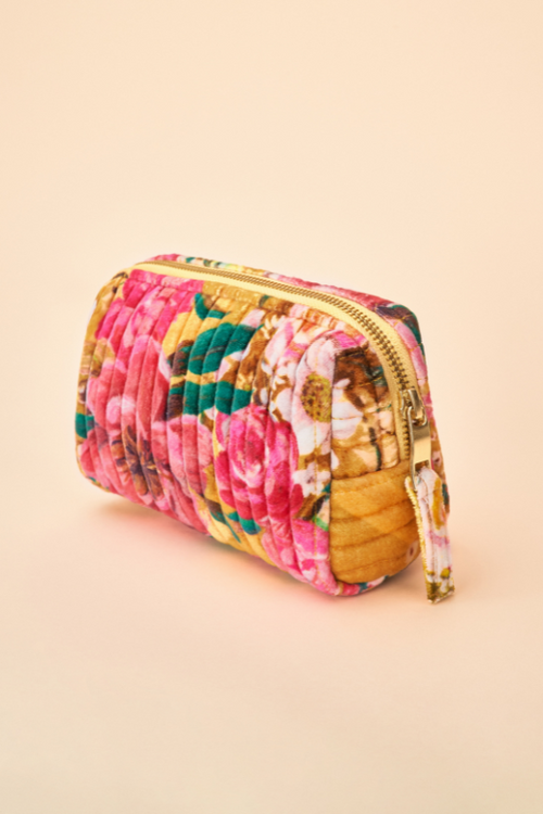 Powder Velvet Vanity Bag. A zip-up makeup bag with a vibrant mustard floral print.