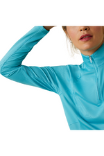 An image of a female model wearing the Ariat Sunstopper 2.0 1/4 Zip Baselayer in the colour Blue.