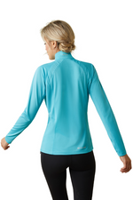 An image of a female model wearing the Ariat Sunstopper 2.0 1/4 Zip Baselayer in the colour Blue.