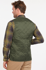 An image of a male model wearing the Barbour Quilted Waistcoat/Zip-In Liner in the colour Olive/Classic.