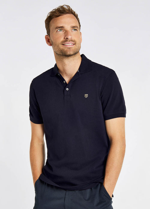 Dubarry Quinlan Polo Shirt. A short sleeve polo with collar, button fastenings, logo embroidery, and anti microbial/UPF 40 finish. Navy.