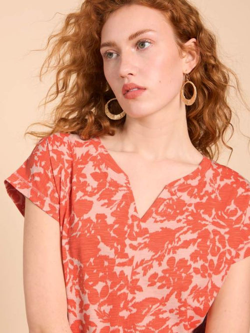 Marc Cain Short Sleeve V-Neck Top. A loose cut T-shirt with short sleeves, V-neck, and side slits, in an eye-catching orange print.