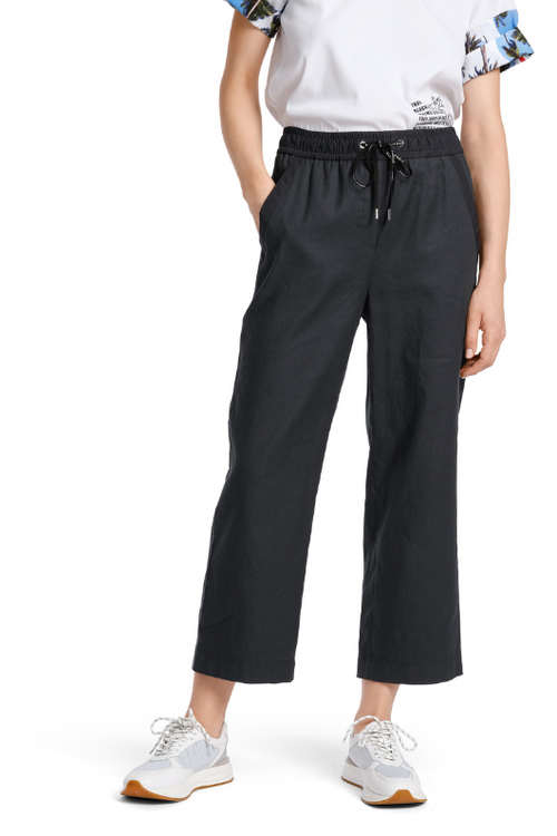An image of a female model wearing the Marc Cain WUSU Linen Trousers in the colour Midnight Blue.