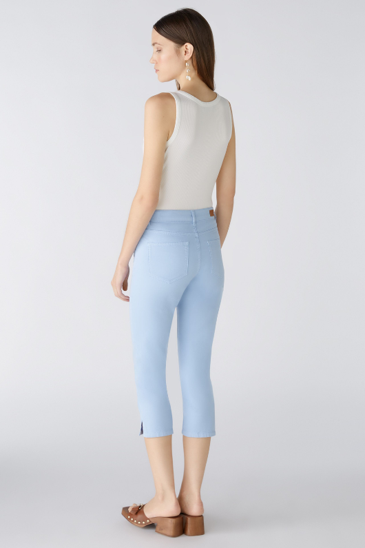 Oui Capri Pants. A pair of slim fit cropped trousers with split hem, pockets, and zip/button closure. Colour Light Blue.
