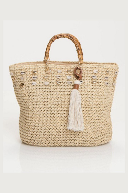 Pia Rossini Tivoli Bag. A summer tote bag made from paper straw, with a bamboo handle, and shell and tassel detail.