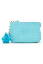 Kipling Creativity Small Purse. A small aqua purse with zipper compartment, multiple inner compartments, Kipling logo, and monkey charm.