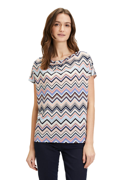 This Betty Barclay Printed Top has a figure-skimming design, dropped mid-length sleeves and a cowl neckline. It features a zig-zag pattern in multiple pastel colours including blue and pink.  