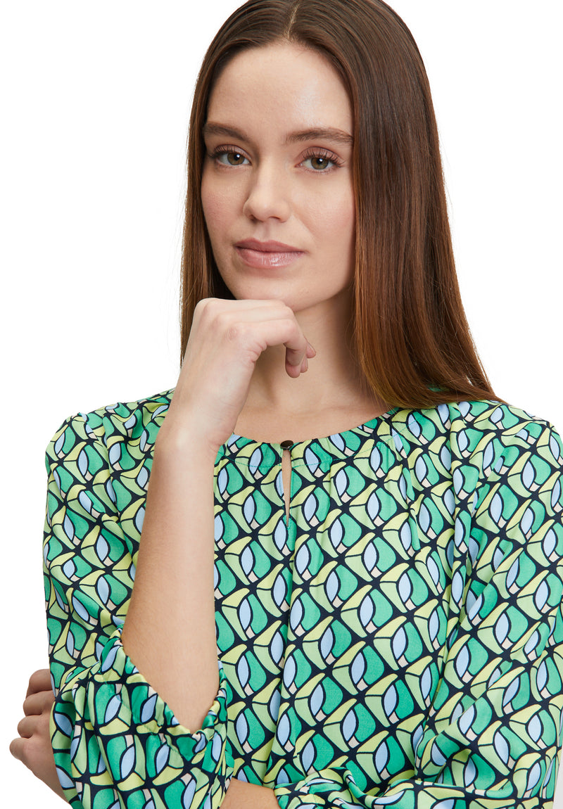 Betty Barclay 3/4 Sleeve Pattern Top. A figure-skimming top with a round neckline, an elasticated waist, and a geometrical print.