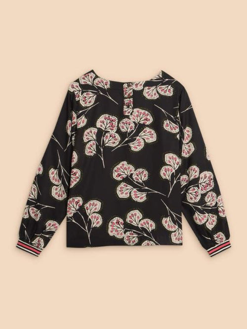 White Stuff Iris Eco Vero Top. A round neck top with long sleeves and pretty pink floral design on a black background.