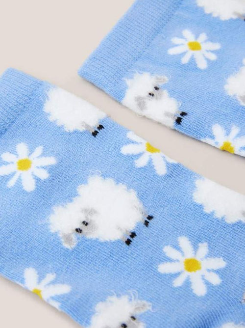 White Stuff Fluffy Sheep Socks. A light blue sock with a fluffy sheep and daisy design all-over.