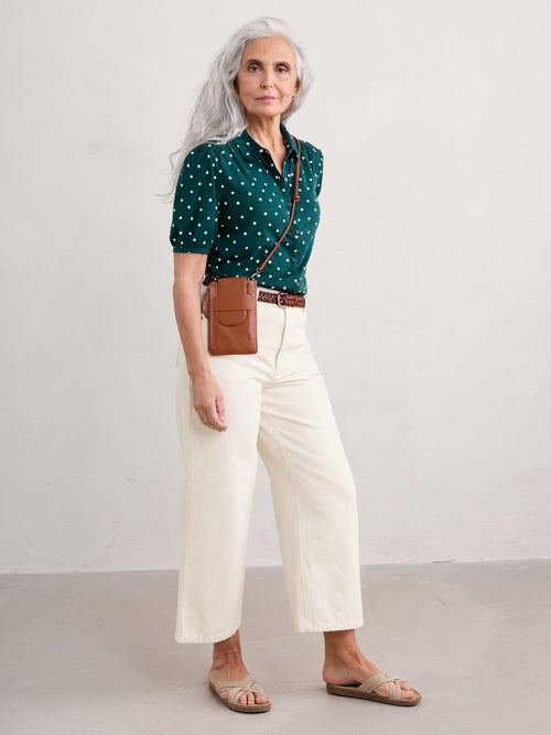 Seasalt Embrace Shirt. A green shirt with white polka dots, featuring a slightly fitted cut, collar, gathered short sleeves and button fastenings.