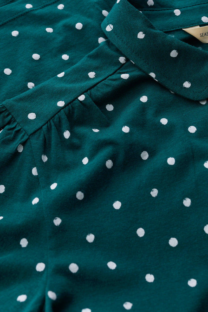 Seasalt Embrace Shirt. A green shirt with white polka dots, featuring a slightly fitted cut, collar, gathered short sleeves and button fastenings.