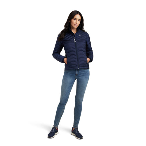 An image of a female model wearing the Ariat Ideal Down Jacket in the colour Navy Eclipse.