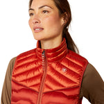 An image of a female model wearing the Ariat Ideal Down Gilet in the colour Iridescent Red.