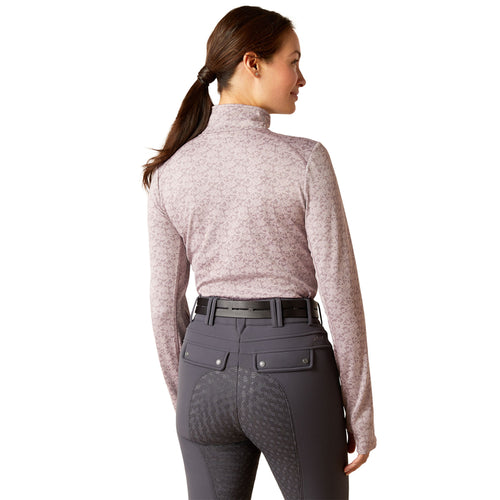 An image of a female model wearing the Ariat Prophecy 1/4 Zip Baselayer in the colour Quail Pink.