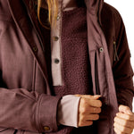 An image of a female model wearing the Ariat Sterling Waterproof Insulated Parka in the colour Raisin Pink.