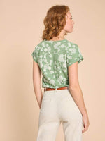 White Stuff Nelly Notch Neck Tee. A short sleeved t-shirt with a notch neck and a green floral print.