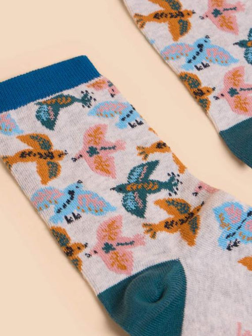 White Stuff Flying Bird Sock. A cream sock with a colourful flying bird design all-over, a mustard toe, and navy heel.