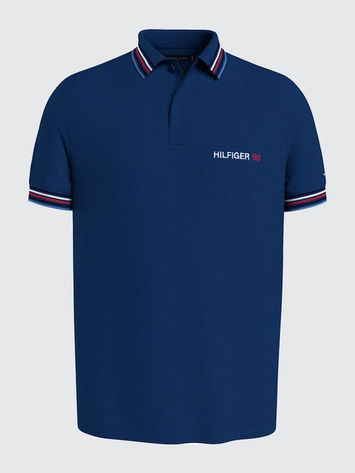 Tommy Hilfiger Contrast Global Stripe Polo. A regular fit, short sleeve polo with logo on the chest and cuff/collar detail.