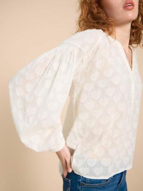 White Stuff Josie Heart Jacquard Top. A pale ivory blouse-style top with notch neckline and all-over elegant, heart jacquard detail.