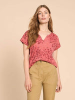 White Stuff Nelly Notch Neck Tee. A short sleeved t-shirt with a notch neck and a pink floral print.