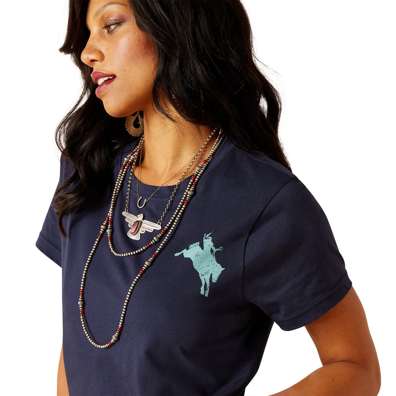 An image of a female model wearing the Ariat Bronco T-Shirt in the colour Navy.