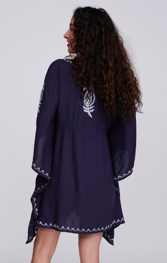 Pia Rossini Tulsa Cover Up. A midi-length cover up with V-neck, drawstring waist, V-neck and embroidery. This cover up is navy with white embroidery.