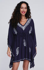 Pia Rossini Tulsa Cover Up. A midi-length cover up with V-neck, drawstring waist, V-neck and embroidery. This cover up is navy with white embroidery.