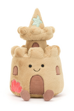 Jellycat Amuseable Sandcastle. A soft toy sandcastle with smiling face, sand coloured fur, and seashell details.