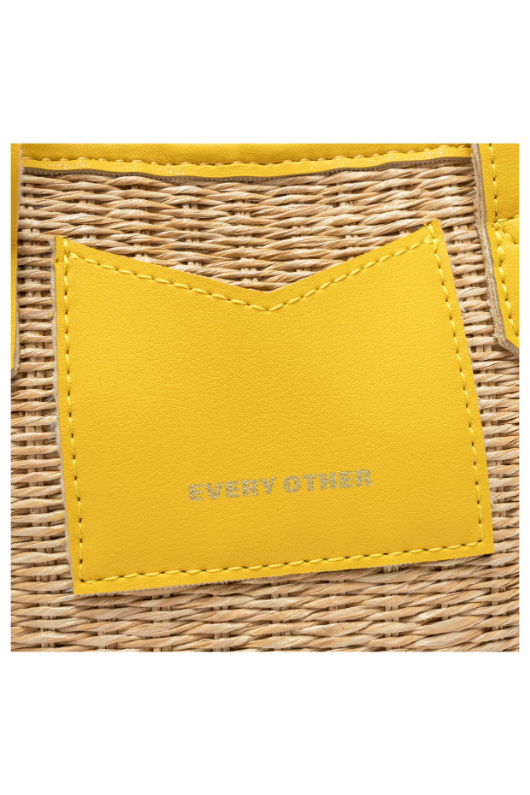 Every Other Straw Rattan Grab Bag. A small raffia bag with yellow faux leather details, top handles, crossbody strap, and fully lined interior with zip pocket.