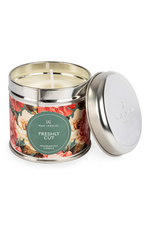 A candle with tin packaging and floral label, with notes of rose, geranium, jasmine, oud, cedarwood, sandalwood, and vetiver.