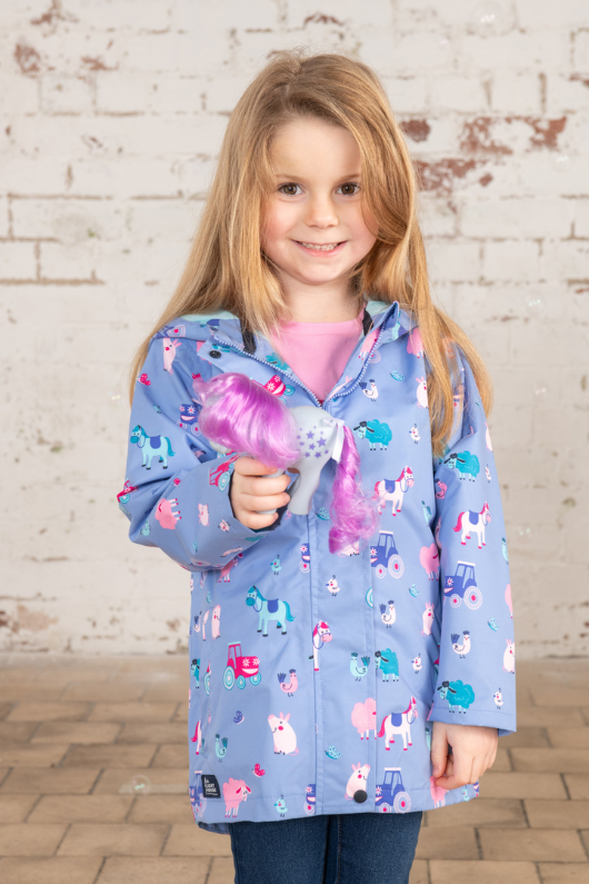 Lighthouse Olivia Jacket. A lightweight, waterproof kids coat with a soft jersey lining, two front pockets, a zip-up front, and a cute farm animal design on a lilac background.