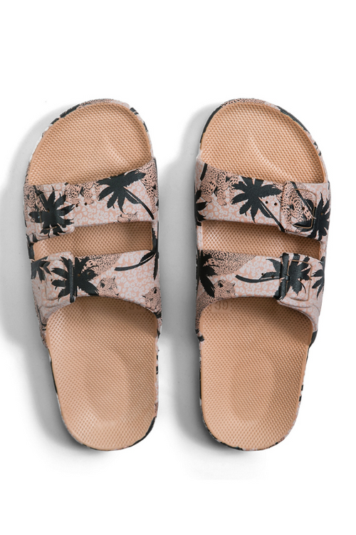 An image of the Freedom Moses Slides in the colour Jungle Camel. Beige sandals with a tree and jungle print all-over
