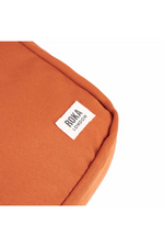 An image of the Roka London Bond Pumpkin Recycled Canvas Crossbody Bag.