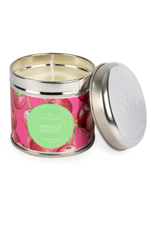 A candle with tin packaging and cherry label, with notes of cherry, pear, raspberry, and vanilla.