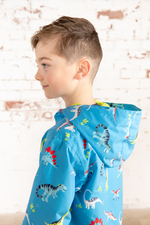 Lighthouse Ethan Jacket. A boys waterproof jacket with a soft jersey lining, zip-up front, and a cool blue dino print.