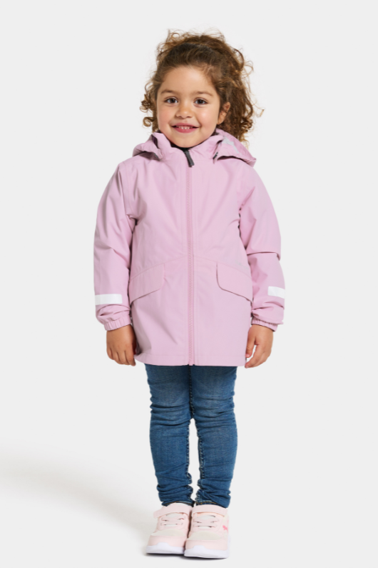 Didriksons Norma Jacket. A windproof kids jacket with a breathable design, a detachable hood, pockets, reflective details on the sleeves and a chin guard