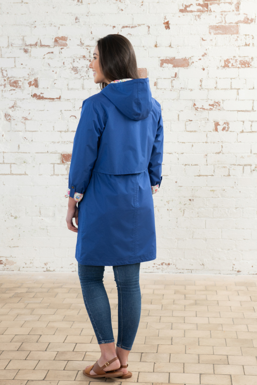 Lighthouse Pippa Coat. A waterproof women's jacket in indigo with an adjustable drawstring waist, a two-way front zip, a cosy cotton blend lining, and handy pockets.