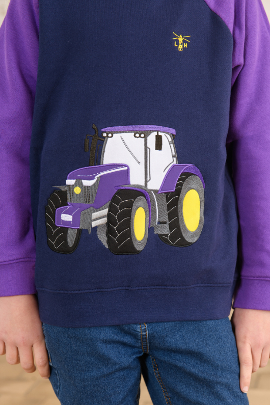 Lighthouse Jill Hoodie. A girls hooded jumper with a kangaroo pocket, purple sleeves & hood, and a fun purple tractor design on the front.