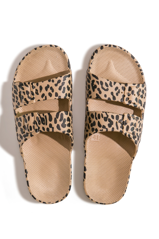 An image of the Freedom Moses Slides in the colour Leo Camel. Beige Sandals with leopard spots all-over.