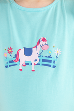 Lighthouse Causeway Swing Tee. A regular fit, kids t-shirt with short ruffle trim sleeves, a crew neck, and a sweet pony design on a light blue background.