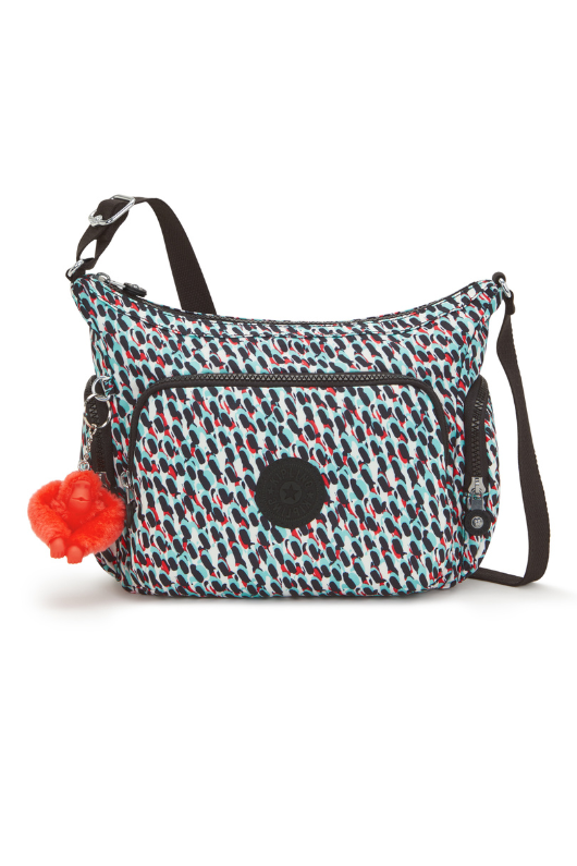 Kipling Gabb S Medium Crossbody Bag. A crossbody bag with adjustable strap, zip closure, multiple compartments, Kipling monkey charm, and all over black and white print.