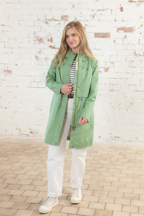 Lighthouse Pippa Coat. A waterproof women's jacket in soft green with an adjustable drawstring waist, a two-way front zip, a cosy cotton blend lining, and handy pockets.