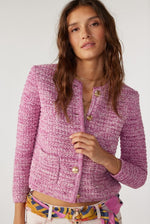 An image of a female model wearing the BA&SH Guspa Long-Sleeved Cardigan in the colour Pink.