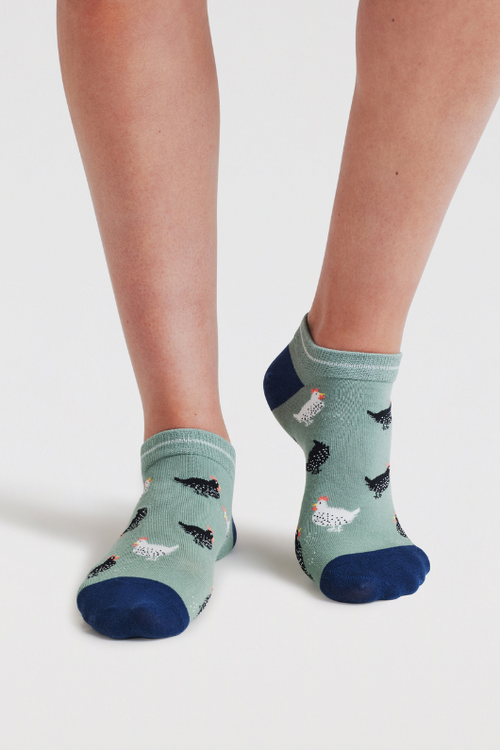 An image of the Thought Socks Celia Chicken Trainer Socks in the colour Pistachio Green.